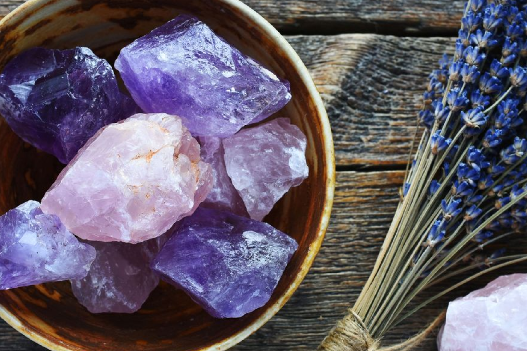 Blue flowers and amethyst crystals in a bowl