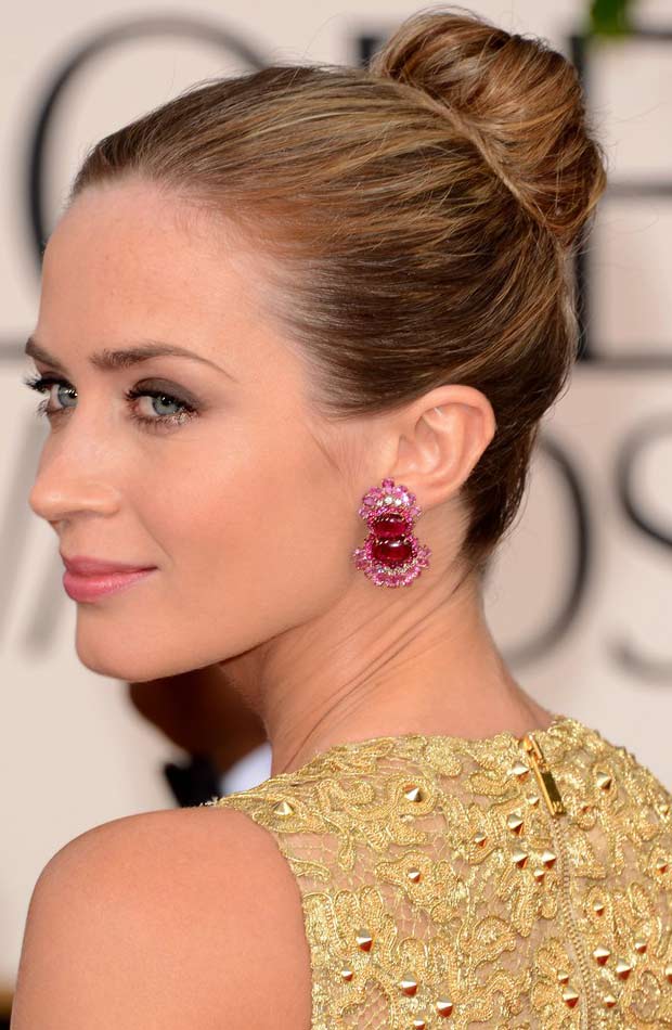 Emily Blunt wearing a golden dress and star ruby earring