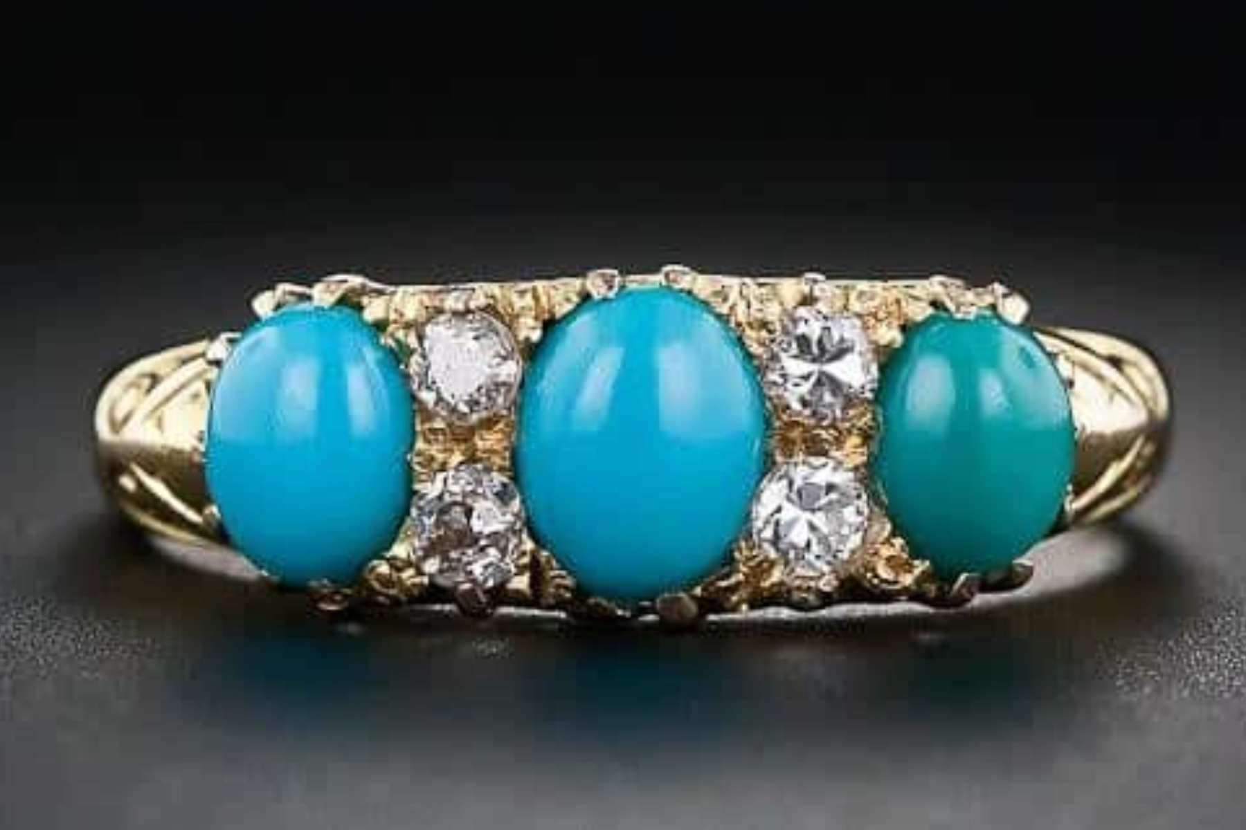 A bracelet featuring three polished turquoise stones