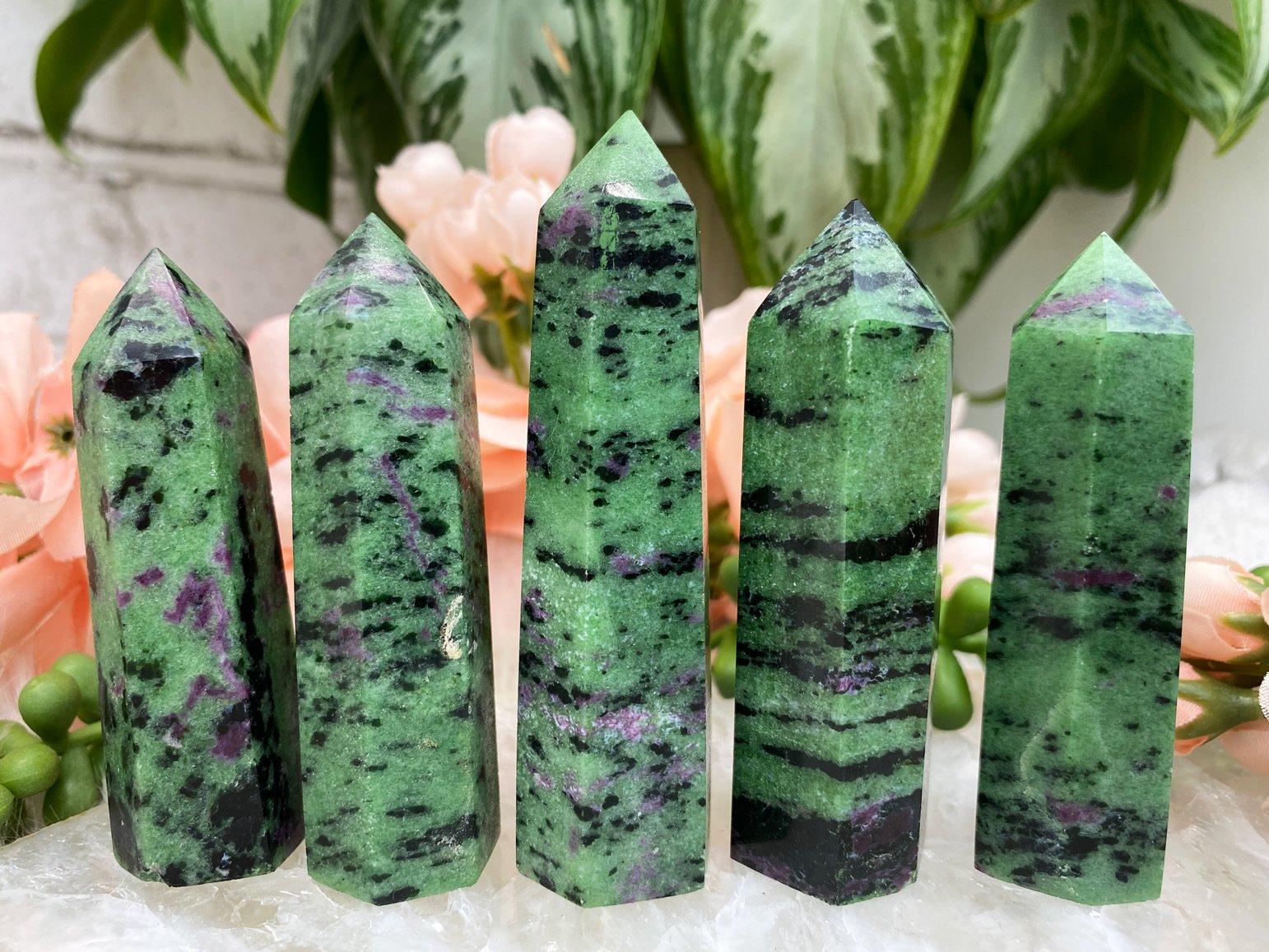 Five ruby zoisite as a display infront of the flowers
