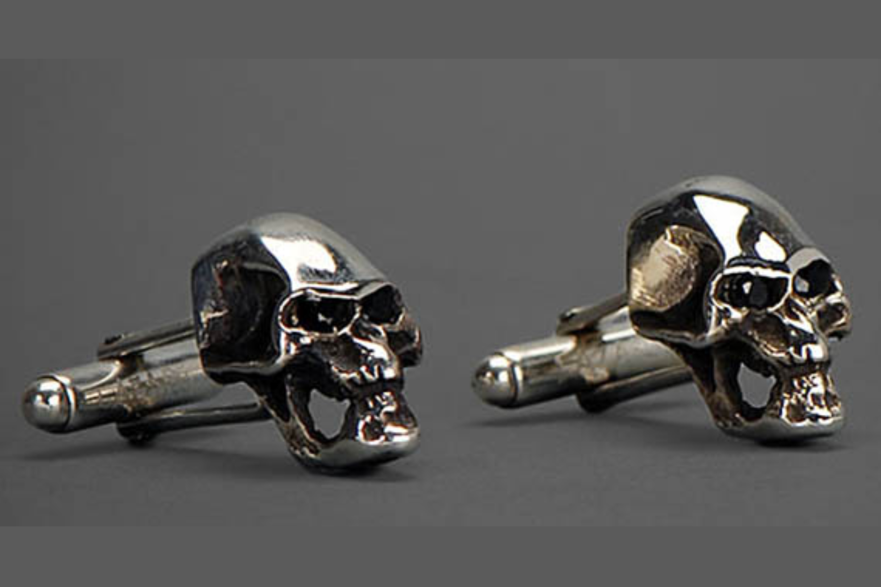 Two cufflinks featuring 3D skulls