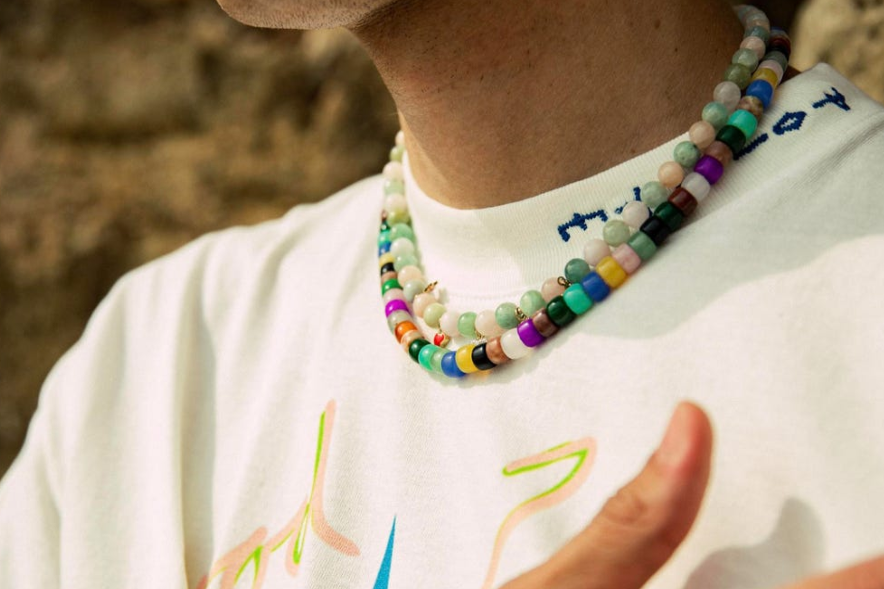 A young man wearing a multi-layered necklaceces-for-kids
