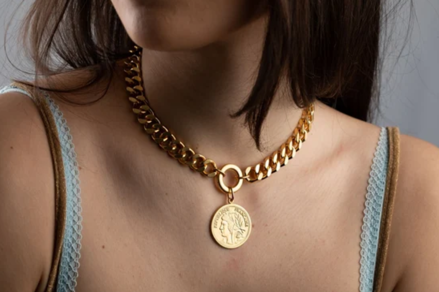 A woman adorned with a gold coin chain necklace