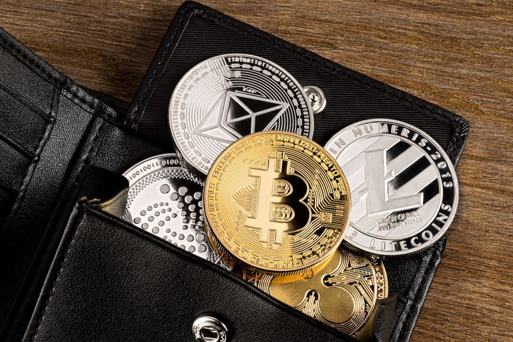 Cryptocurrency coins in a physical wallet