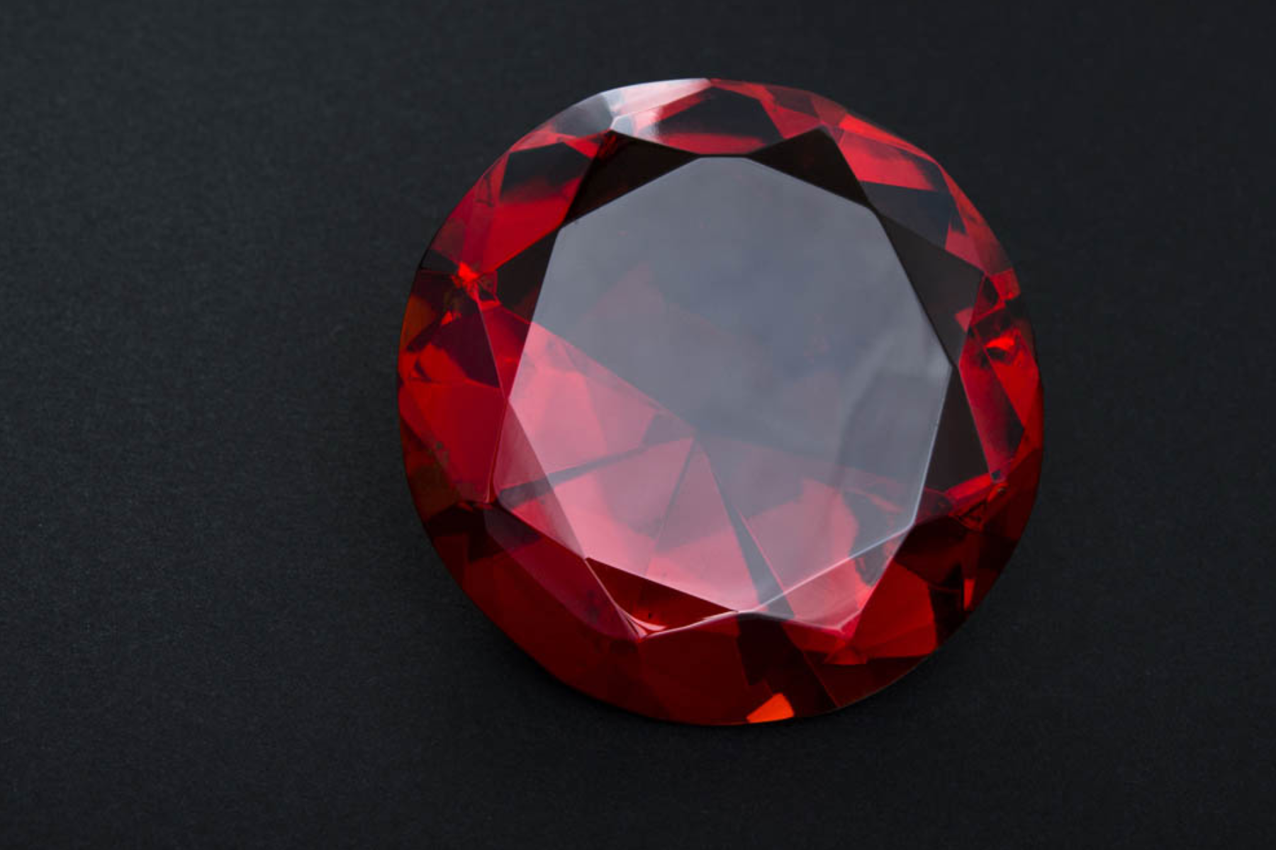 A Ruby gemstone on a black background
