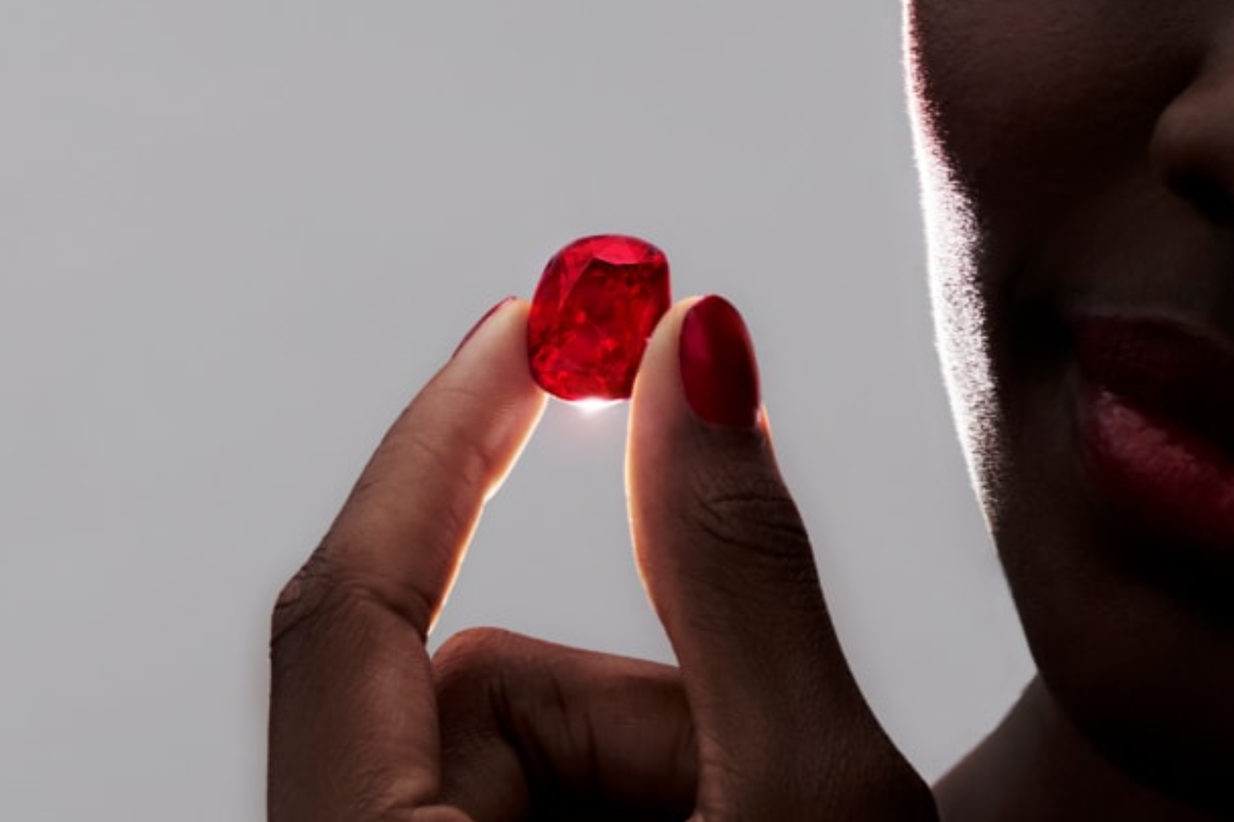 The gem held by a woman was cut from a record-breaking 101-carat rough stone unearthed in Mozambique