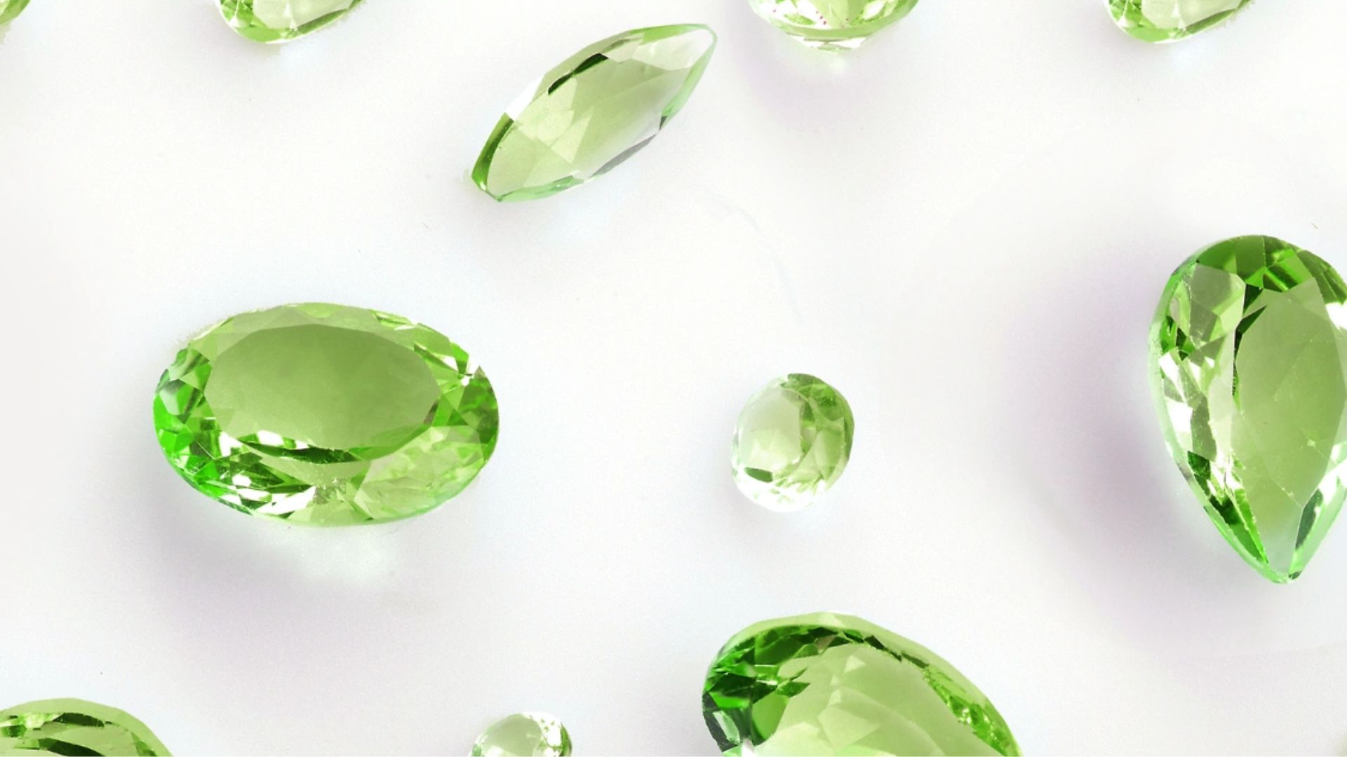 Green Peridot Gemstone On White Surface