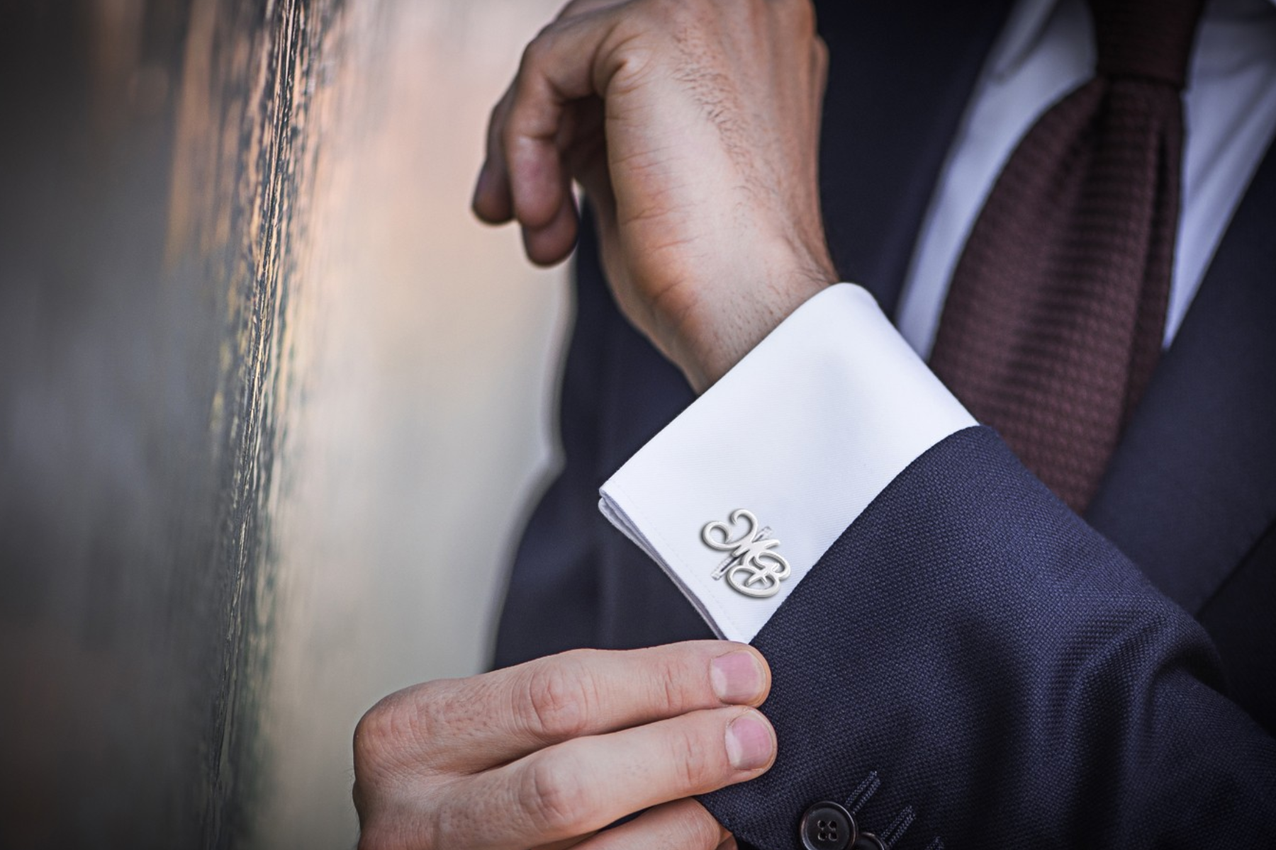 A customized cufflink worn by a man in a formal suit