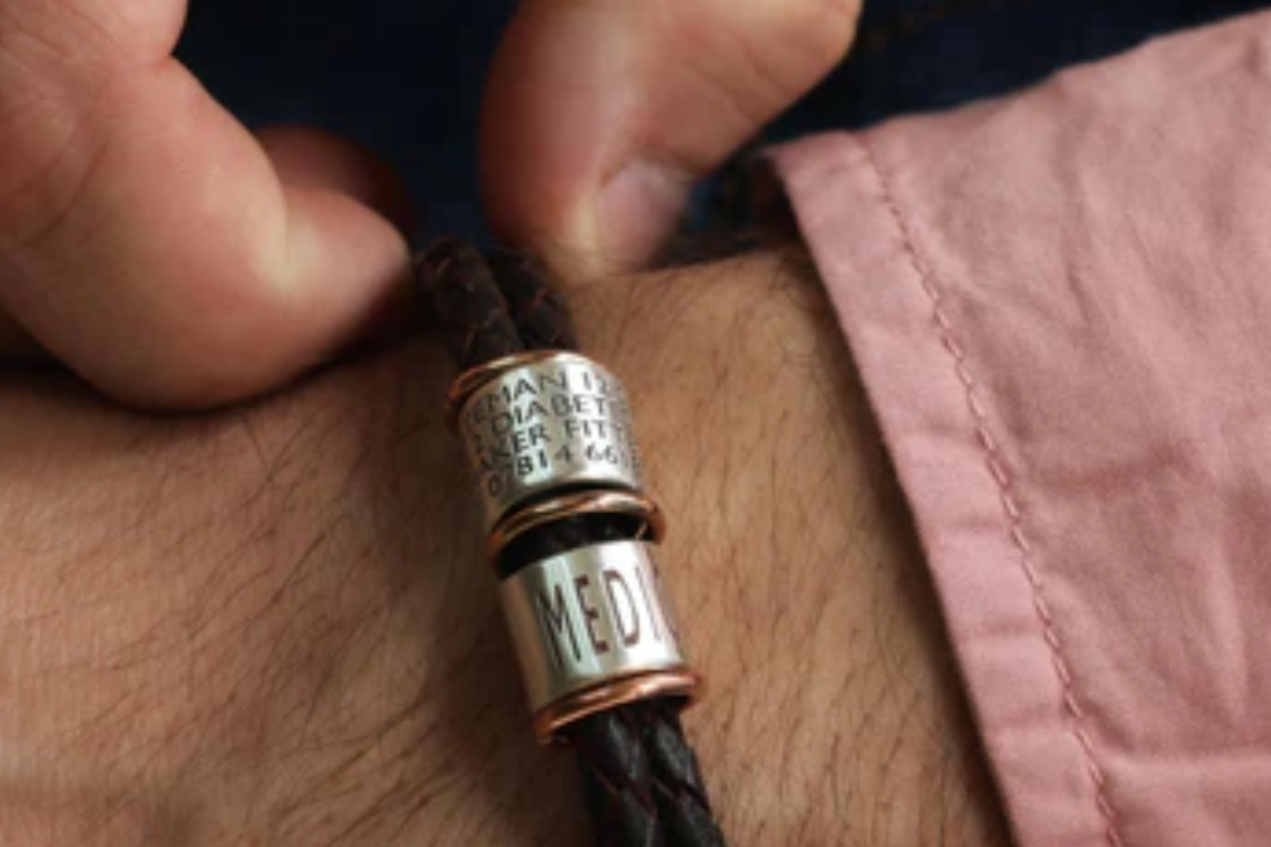 A medical alert bracelet on the wrist of a person