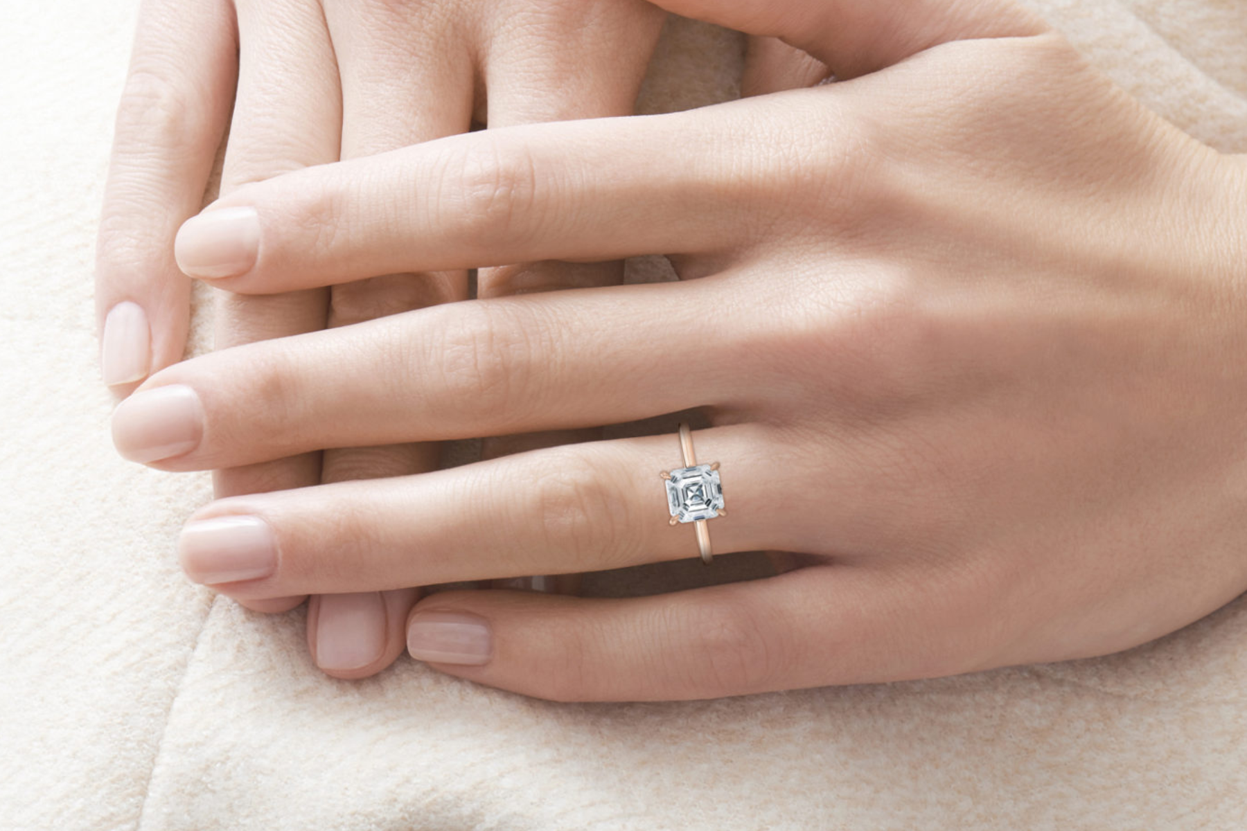 Asscher diamond engagement ring on the hand of a woman
