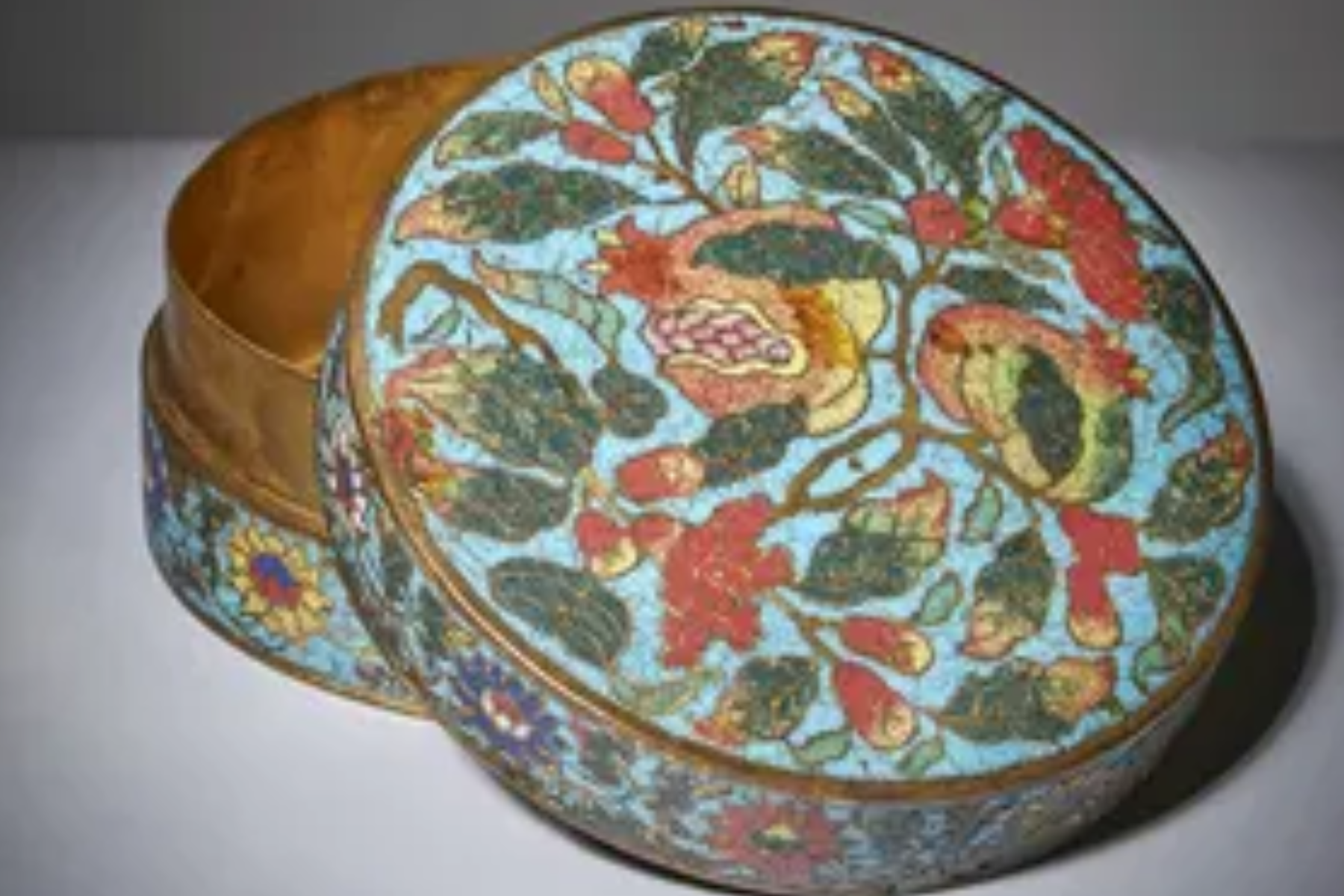 Chinese cloisonné "pomegranate" box and cover from the 15th century Ming period has been discovered in a dust-filled cabinet in the attic of a family home