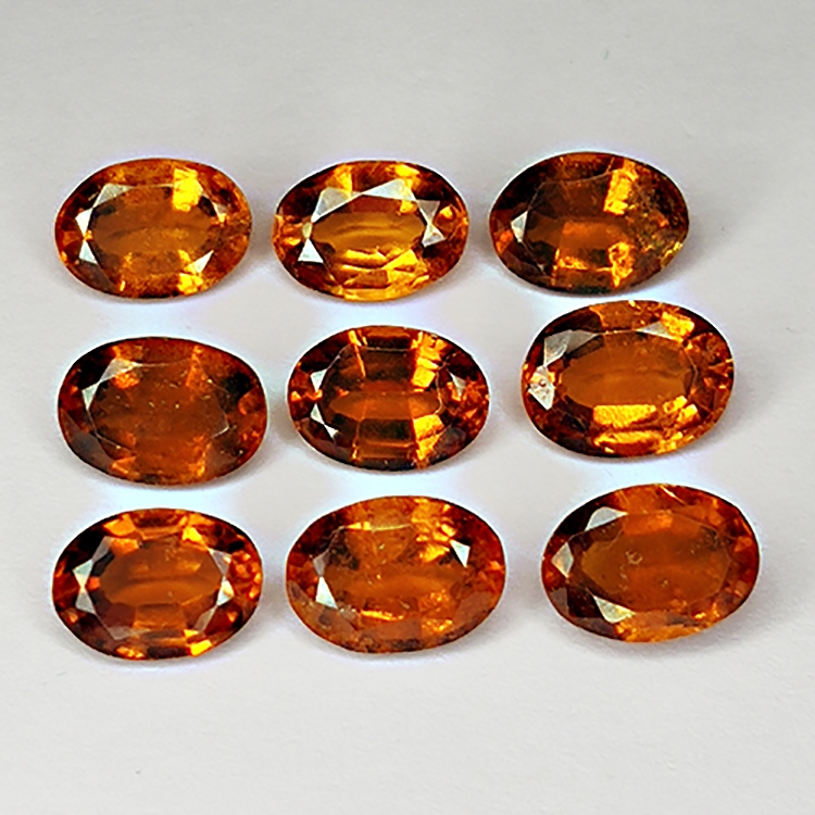 Nine oval shaped hessonites