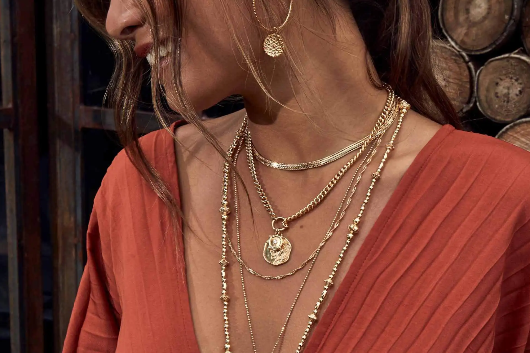 A woman wearing layered necklaces