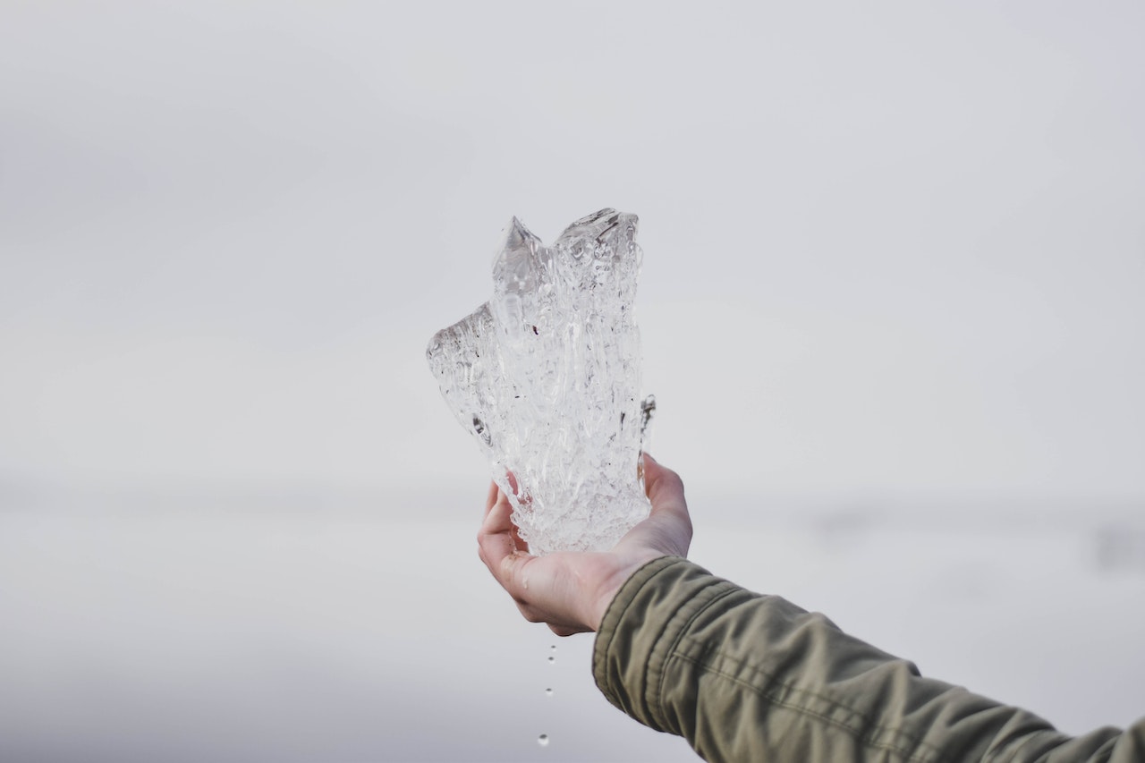 Person Holding Clear Crystal Stone