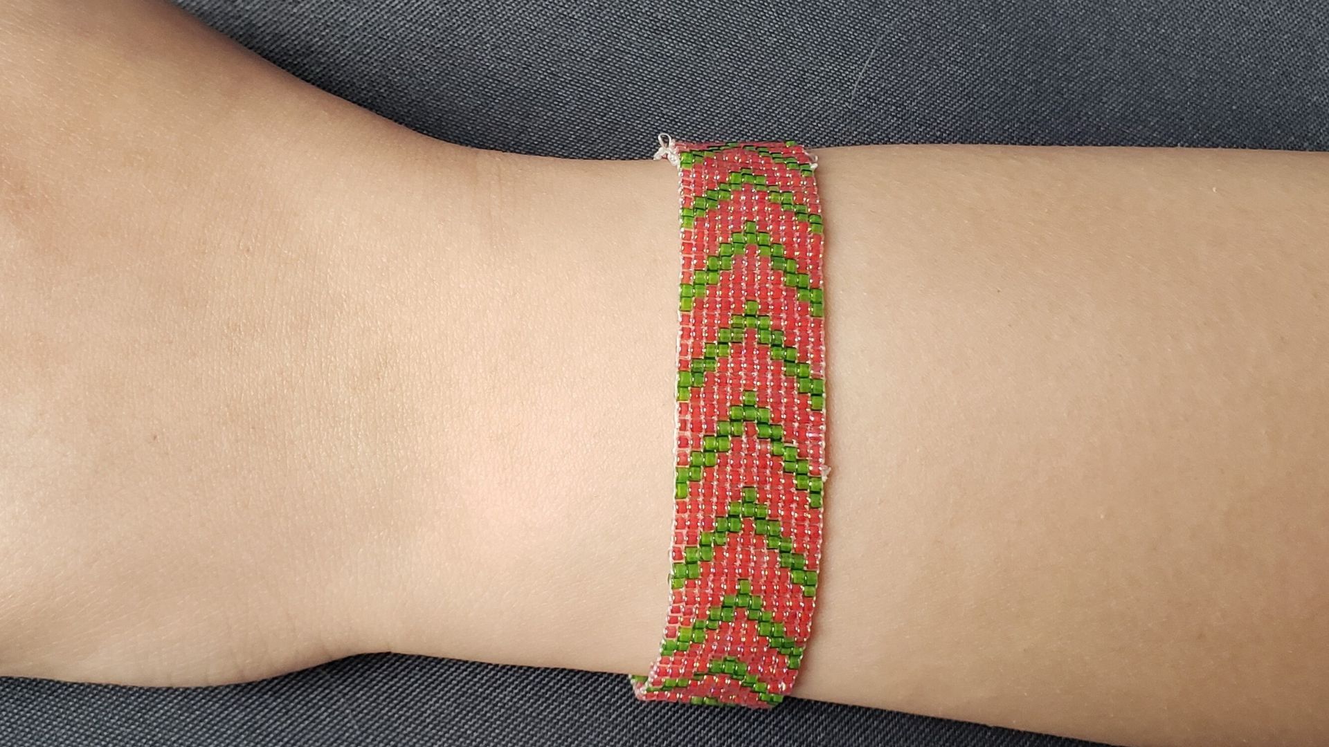Red And Green Bracelet On Woman's Wrist