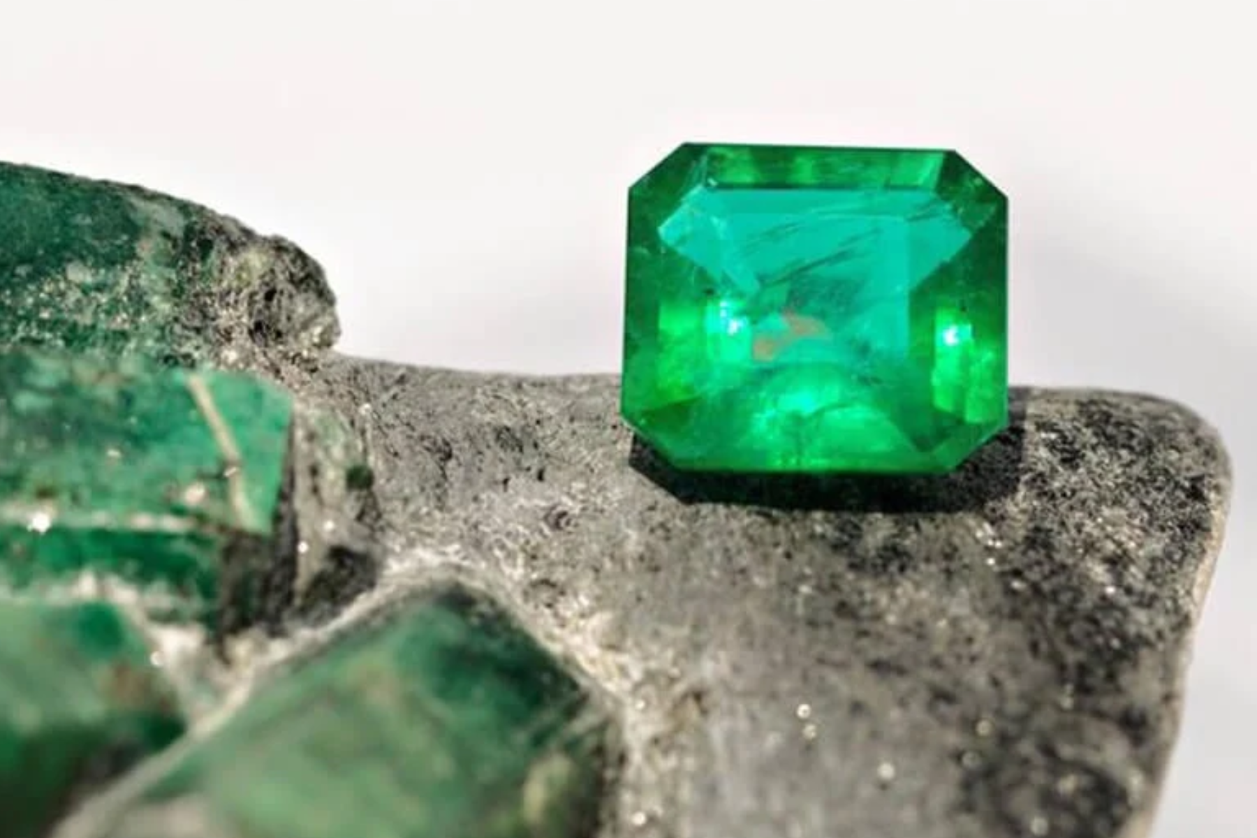 Emerald green standing on a rock