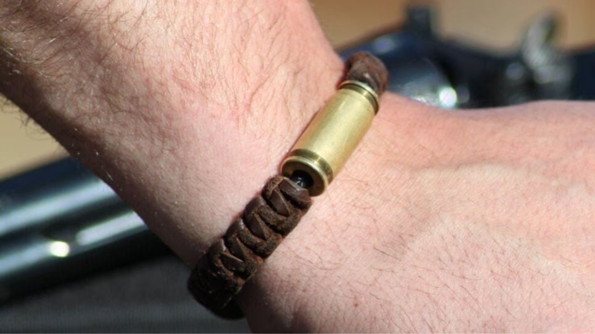 Man Wearing Leather Bracelet With Bullet Casing Lock