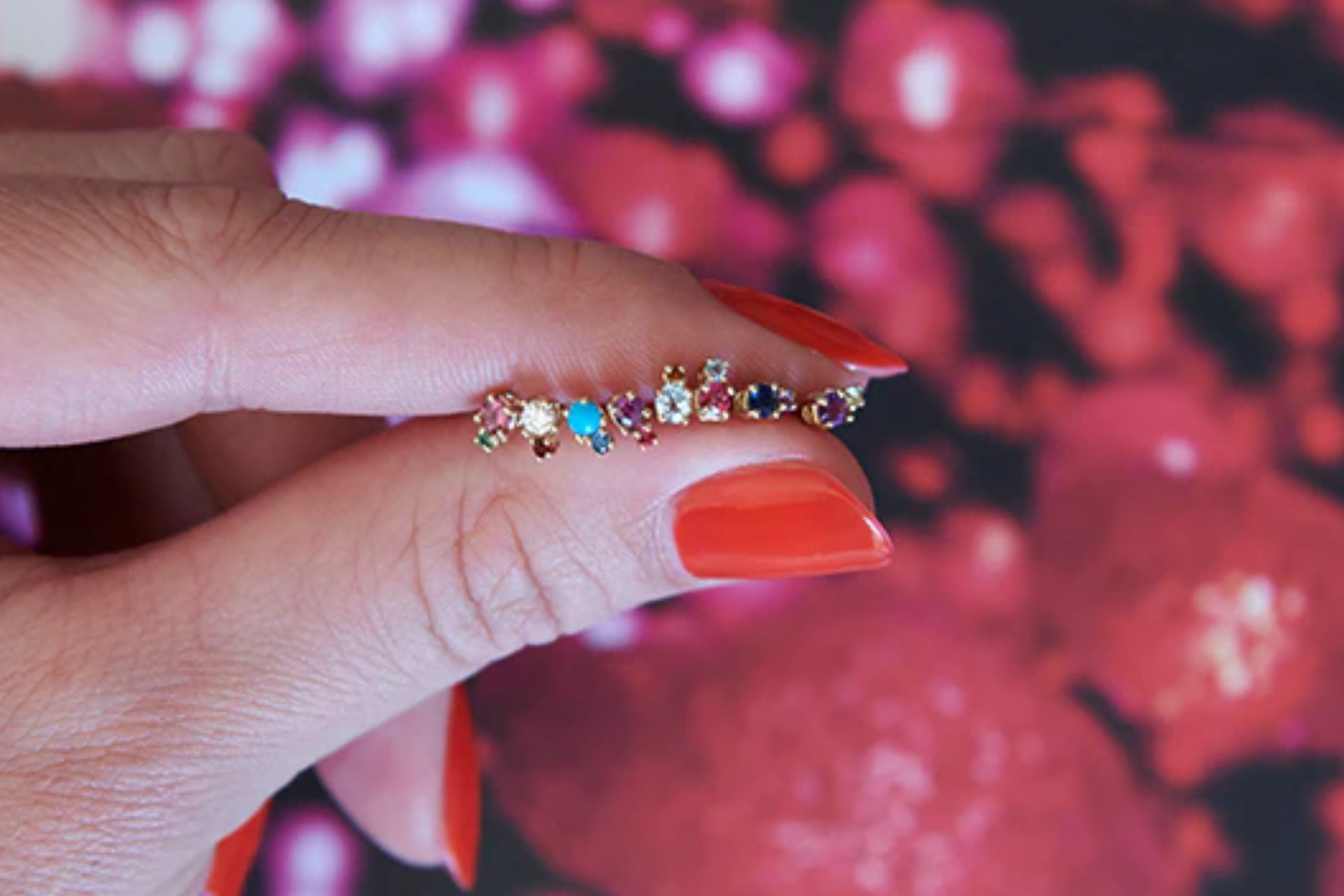 A female hand holding a birthstone ring