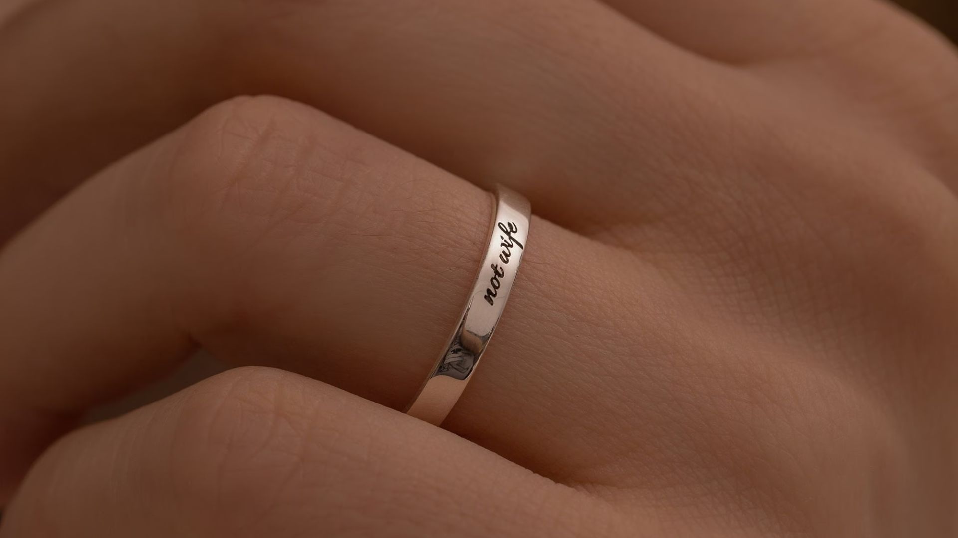A Woman Wearing Ring With Engraved Design