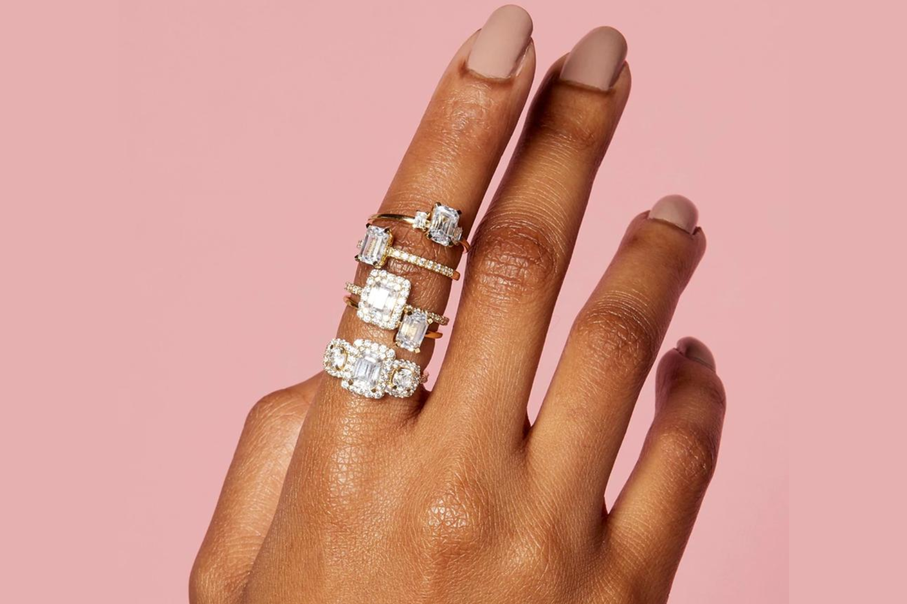Five engagement rings on a woman's finger