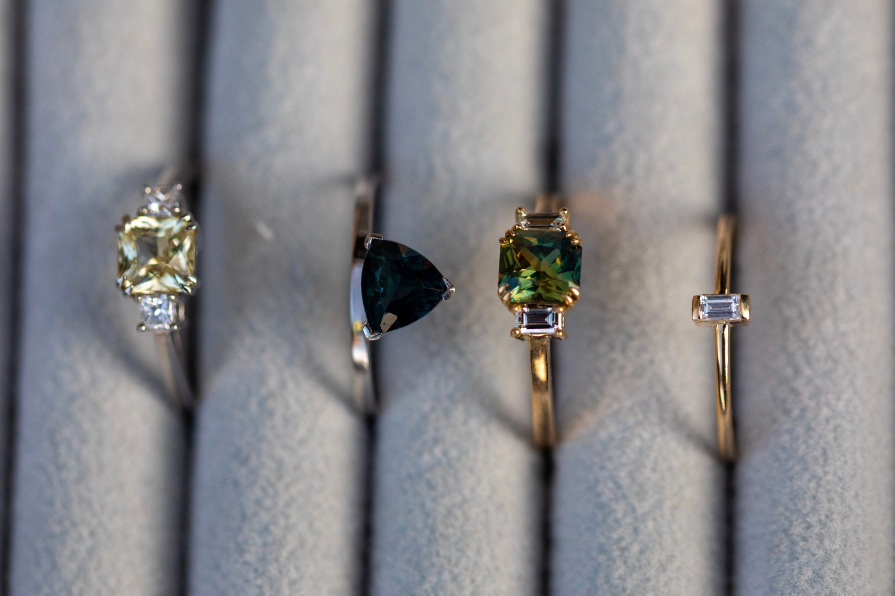 The image shows four distinct cuts of gemstone rings
