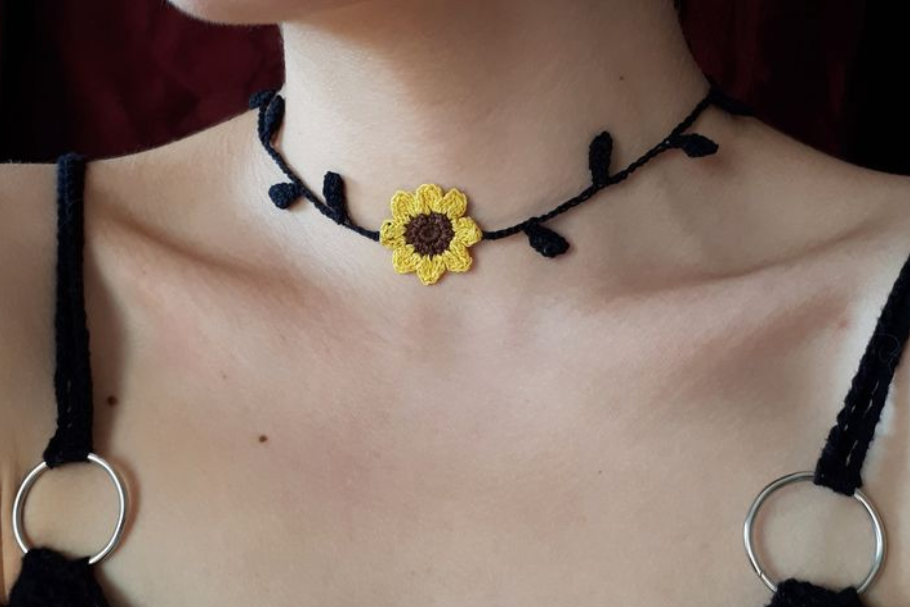 A woman wearing a sunflower choker