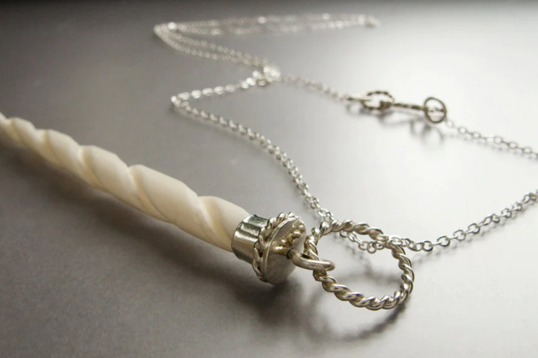 A necklace with a white unicorn horn