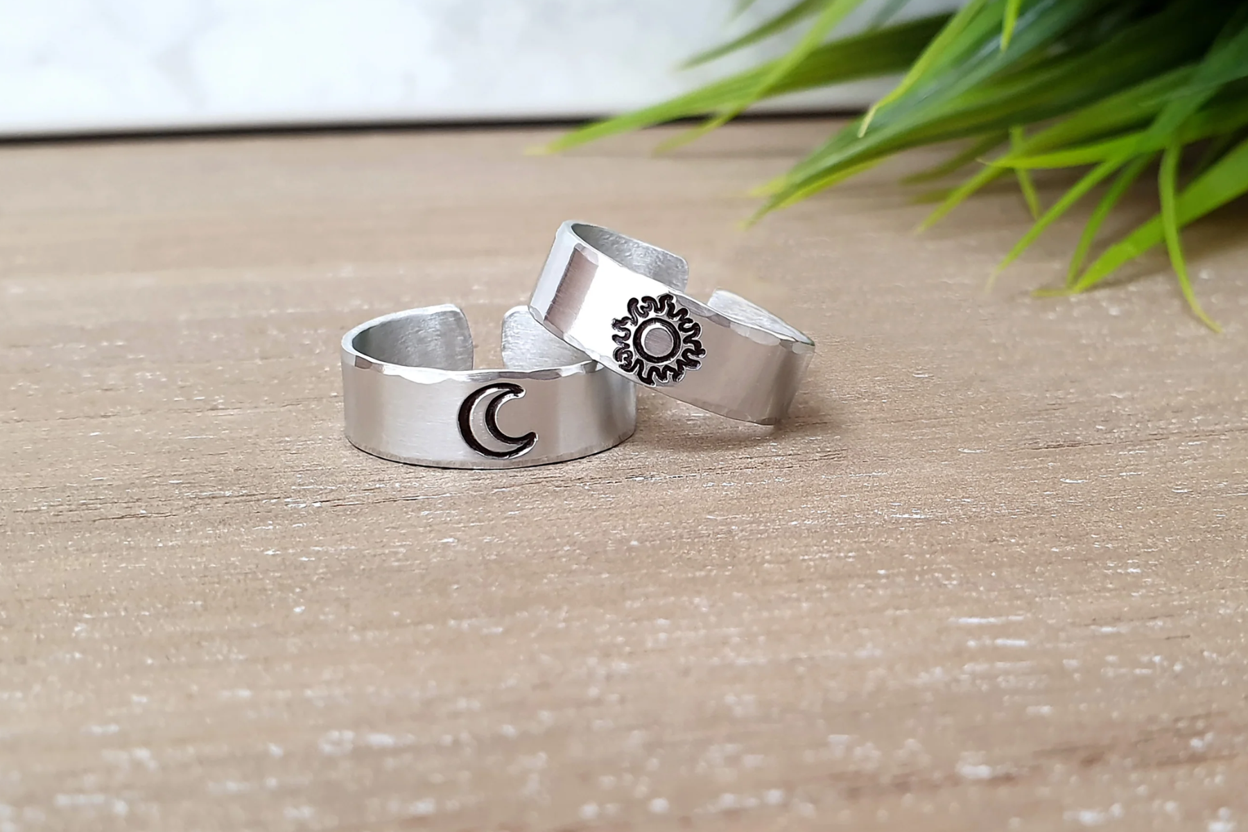 Platinum rings with the sun and moon on top of the table