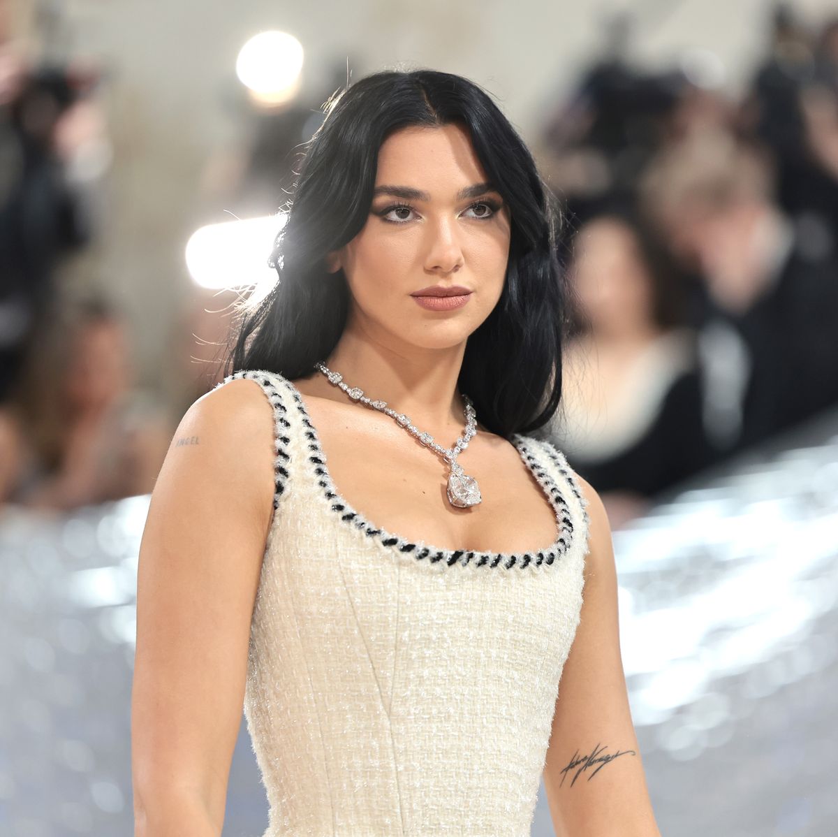 Dua Lipa attends the 2023 Met Gala with a huge diamond necklace and classy white dress