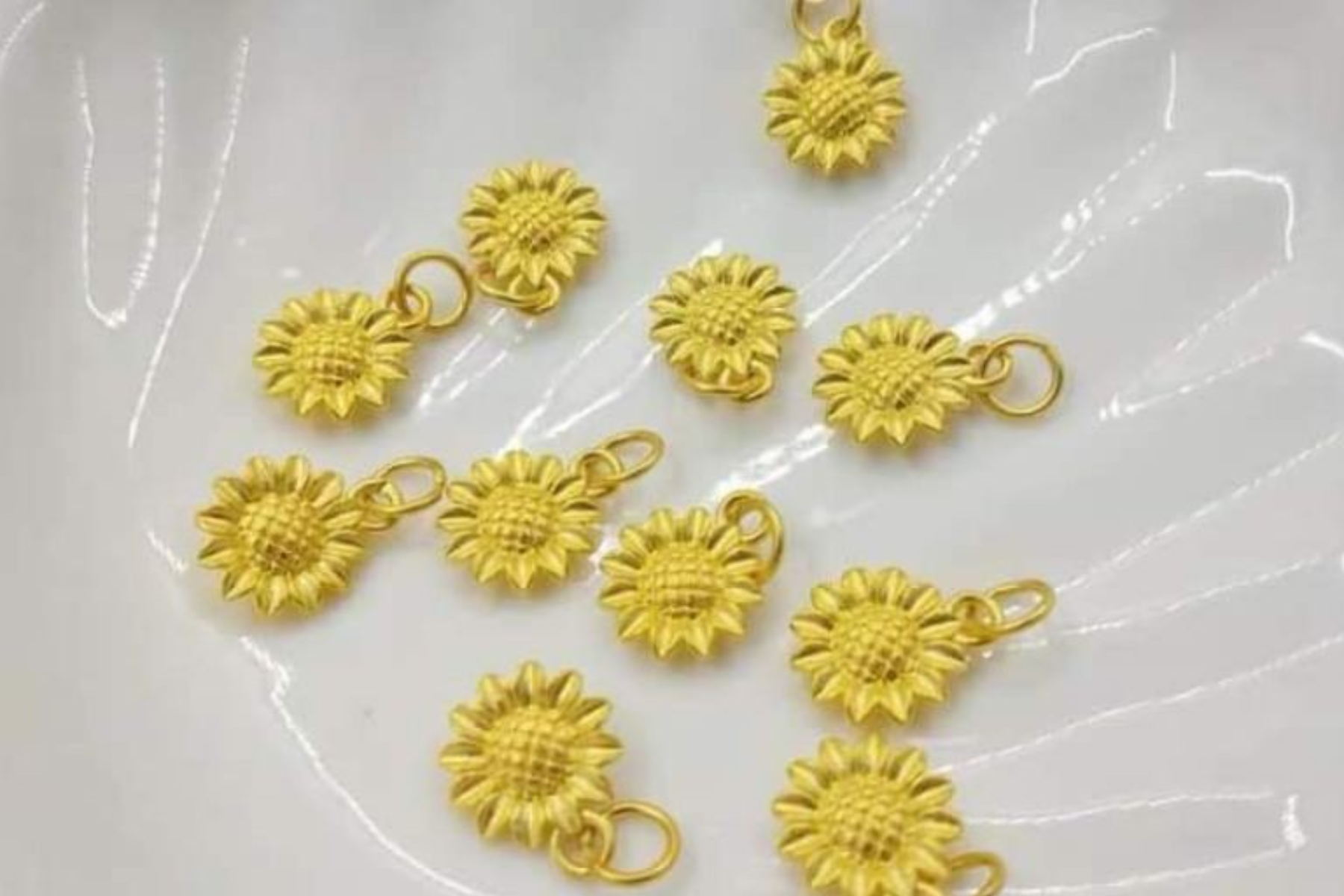 A photo of eleven yellow sunflower pendants