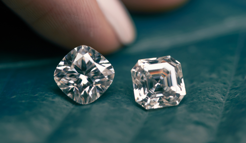 A photograph of two diamonds, each with a different cut