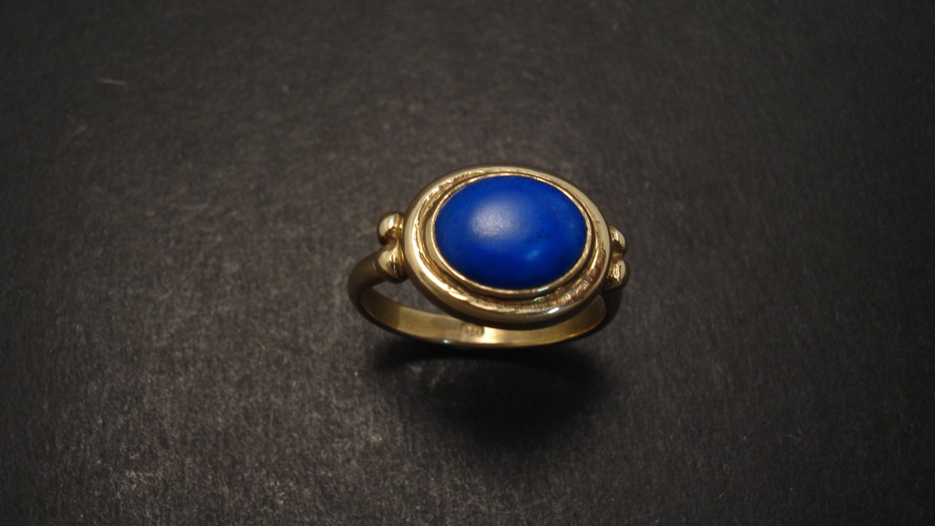 A Blue Stone Ring With Black Background