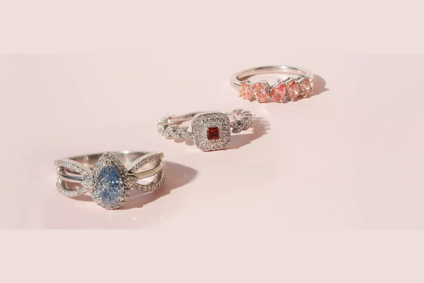 Three diamond engagement rings of different colors