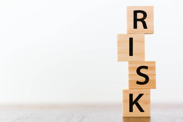 The Word Risk Spelled On Wooden Tiles Stacked Vertically
