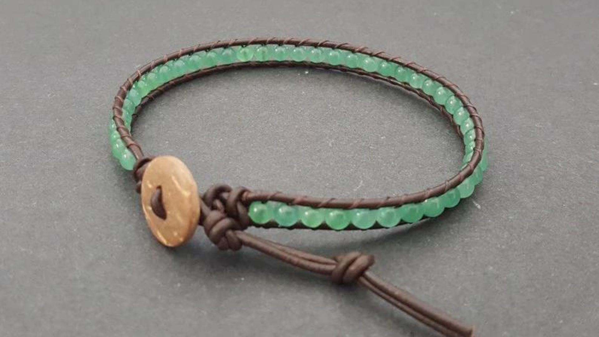 Green Beads In A Leather Bracelet