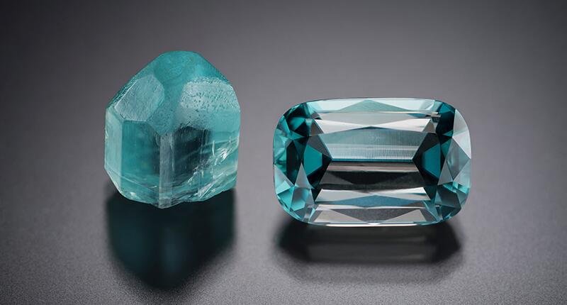 A photograph of raw and cut grandidierite gemstones