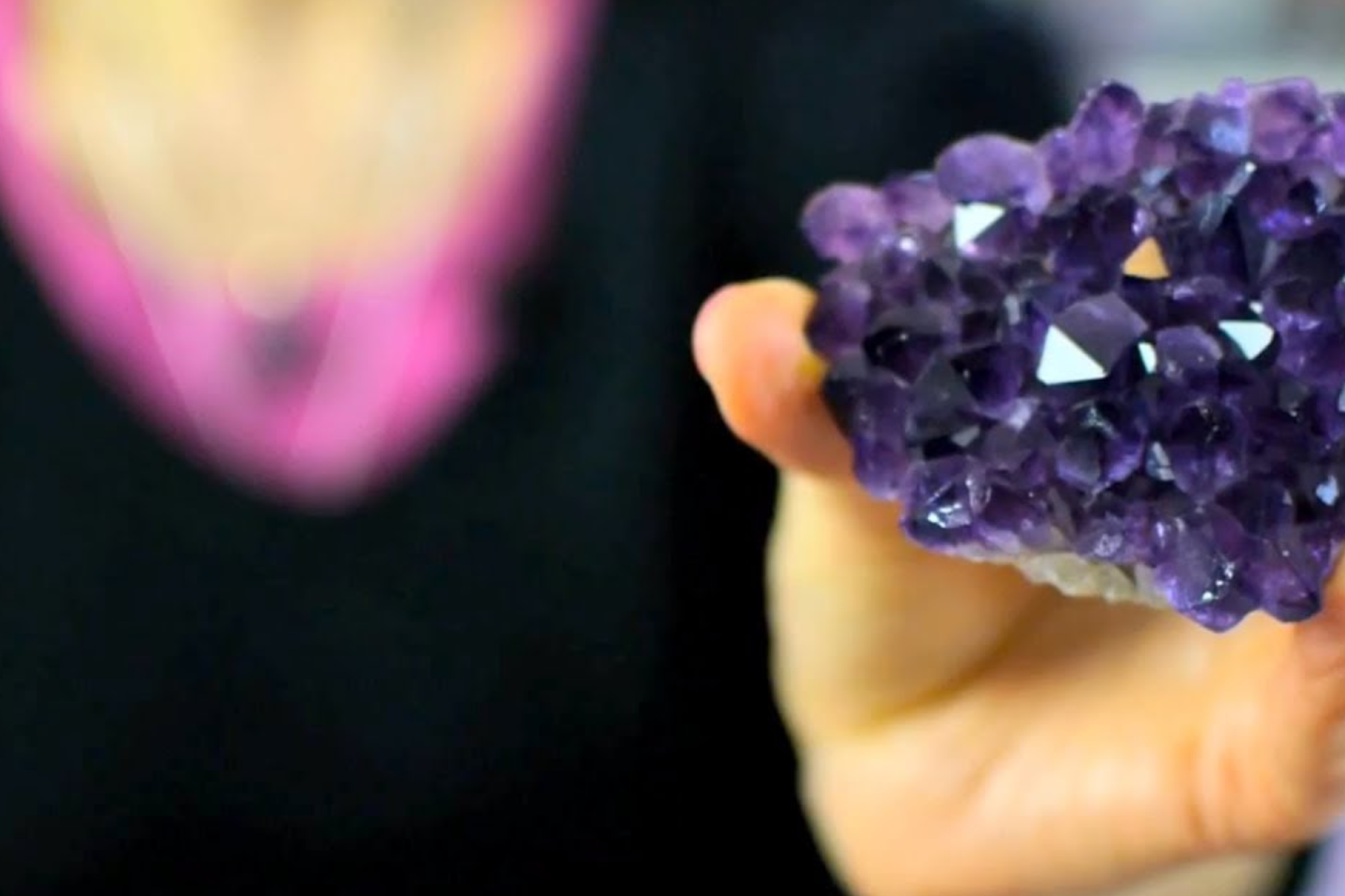 An image of a person holding an amethyst stone