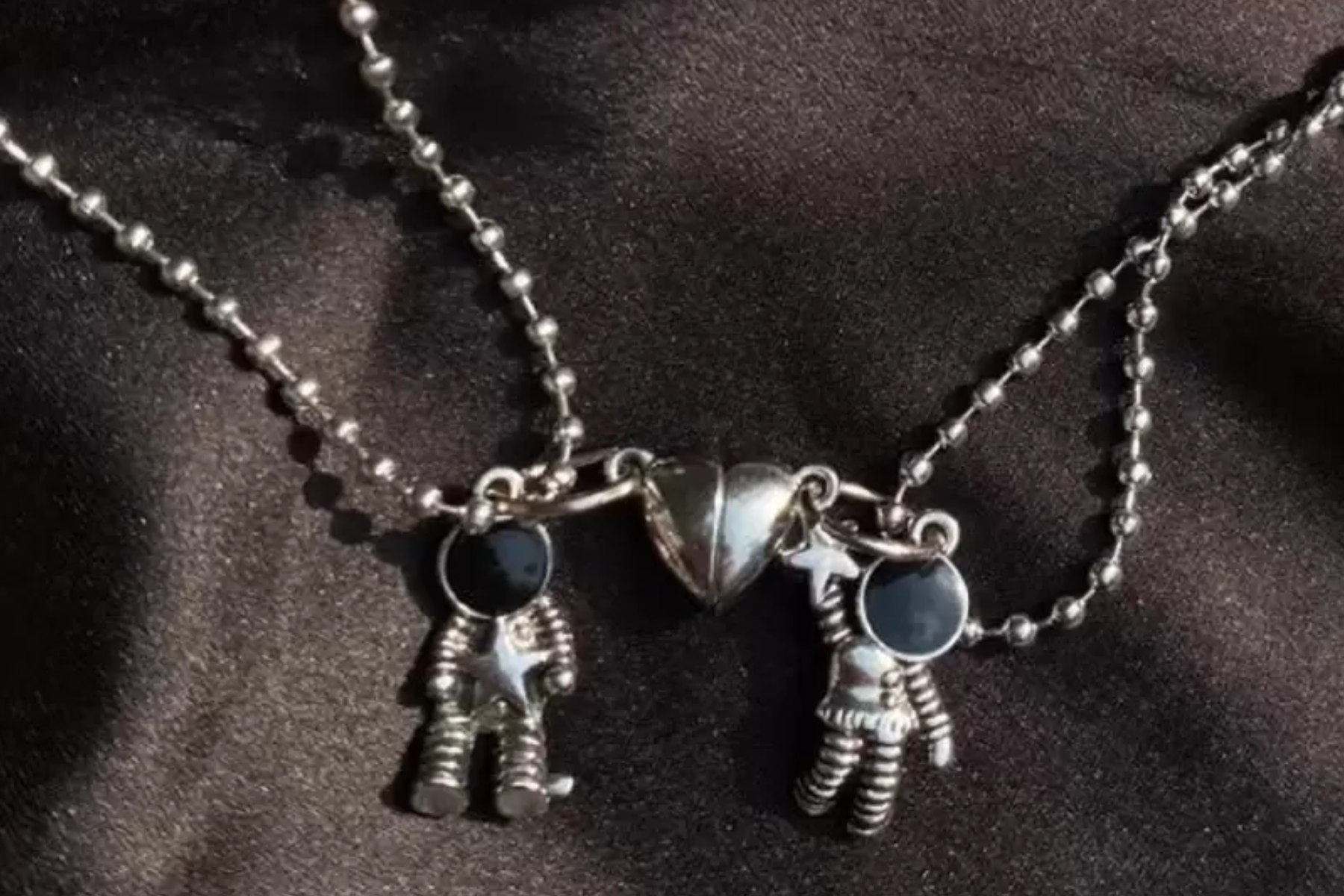 Magnetic platinum necklace with an astronaut couple design