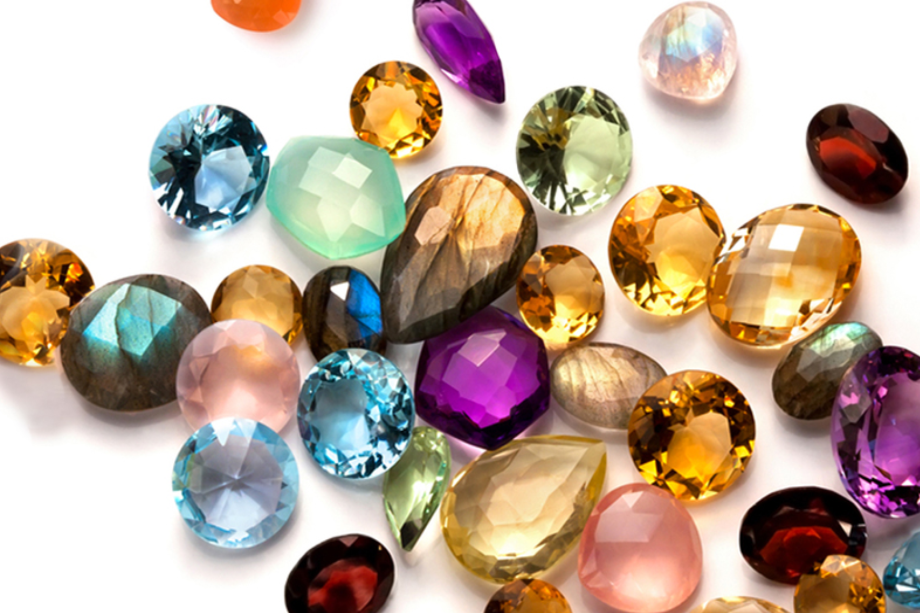 The image depicts a group of valuable gemstones