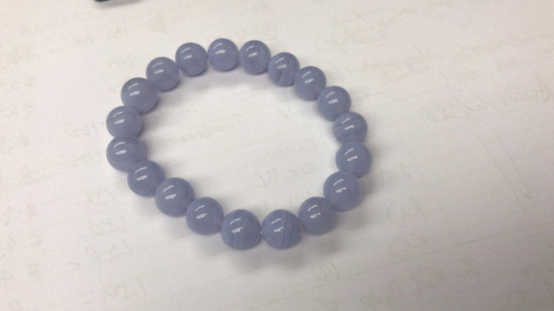A Bracelet Placed On A White Paper