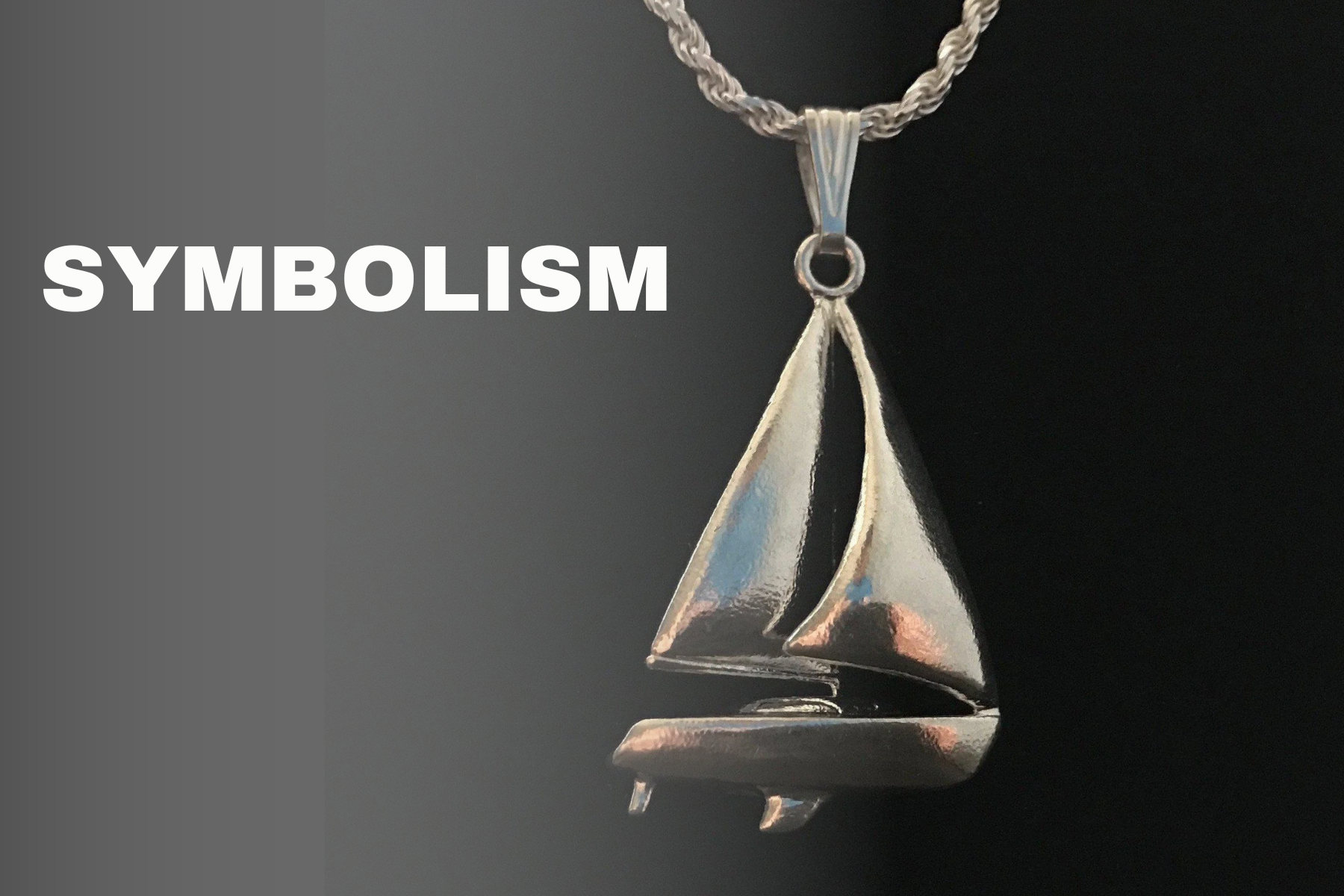 A pendant of a silver sailboat on a dark background with the word "symbolism" next to it
