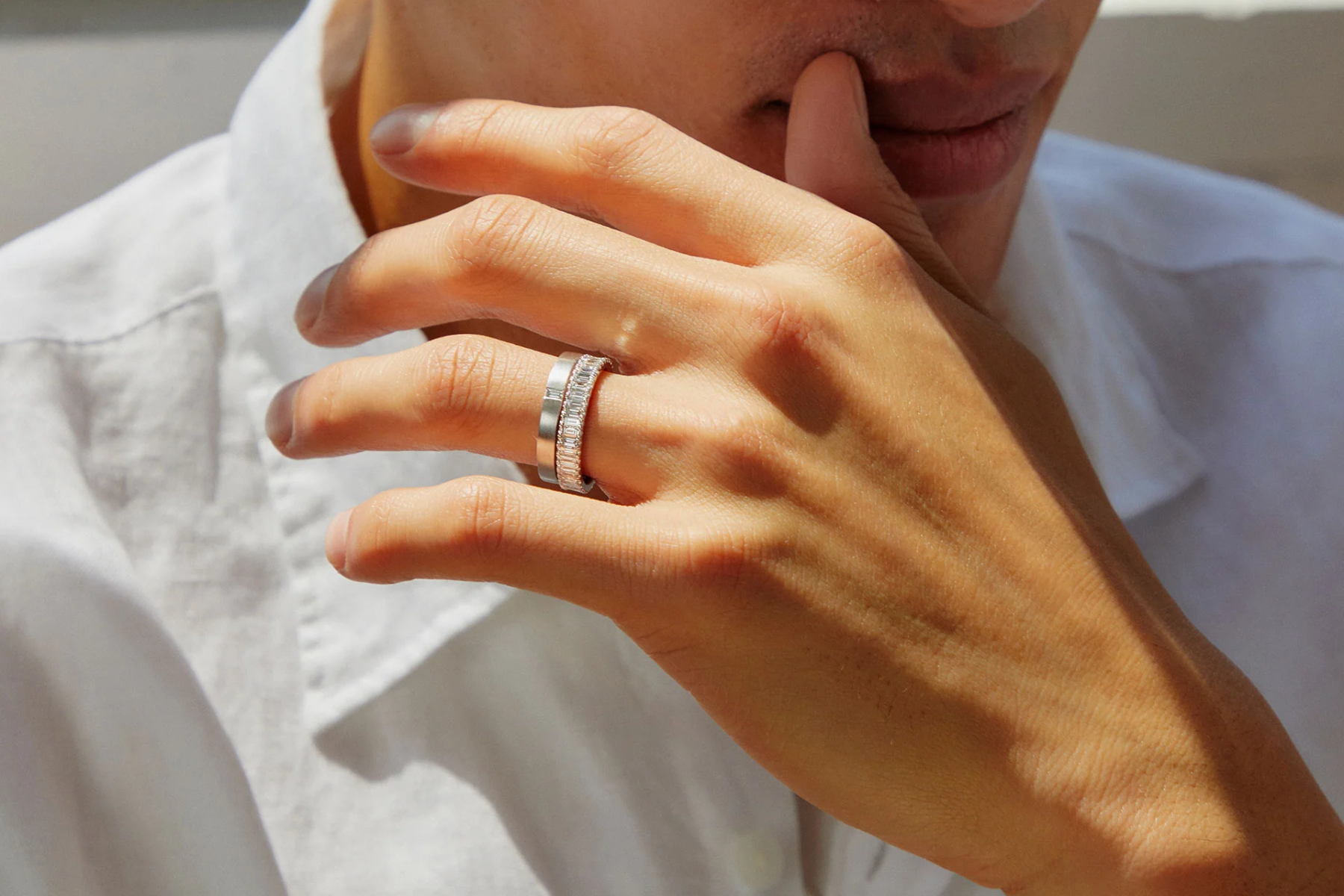 A man wearing a baguette diamond engagement ring