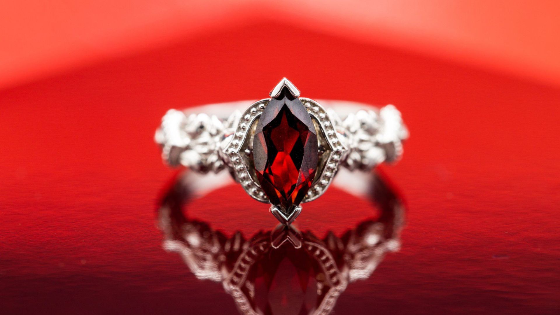 A Ring Of Red Stone With A Red Background