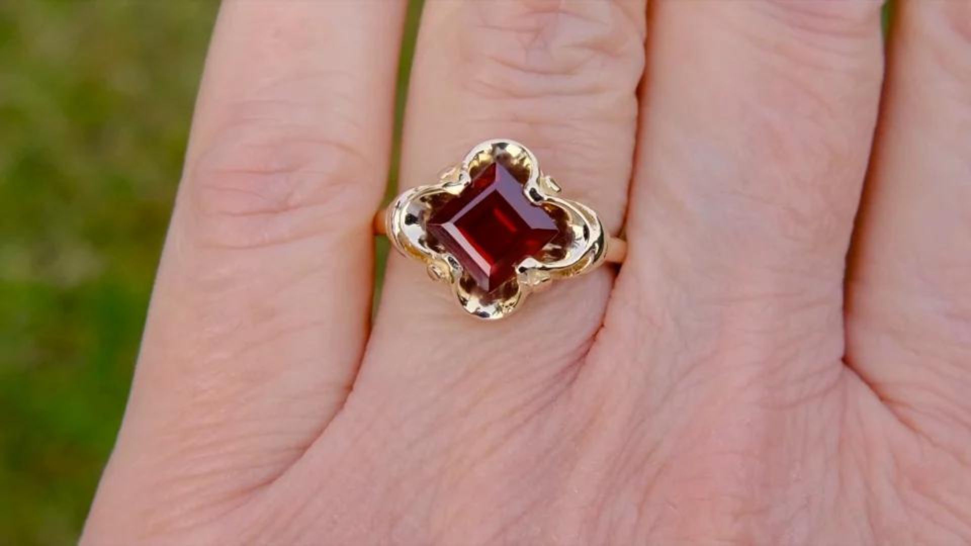 A Woman Wearing Red Stone Ring