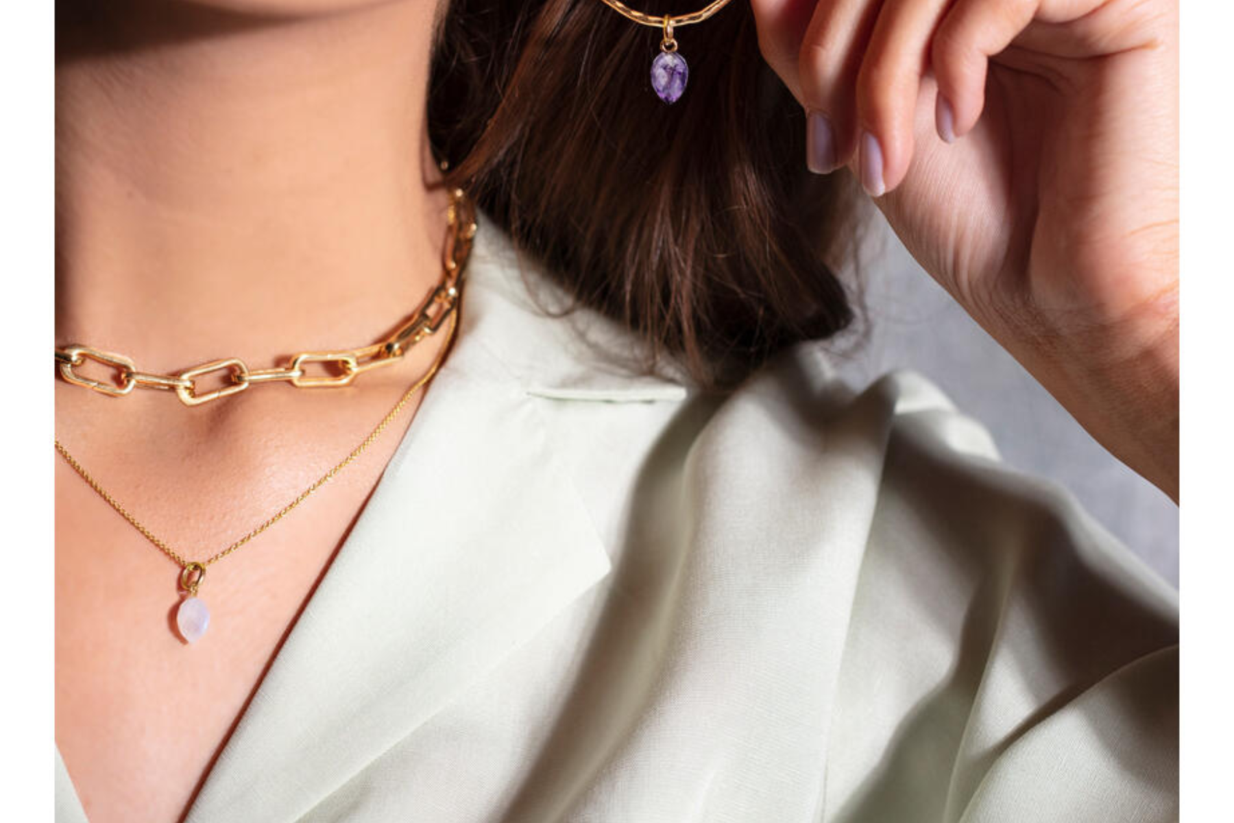A close-up shot of a woman wearing birthstone jewelry set