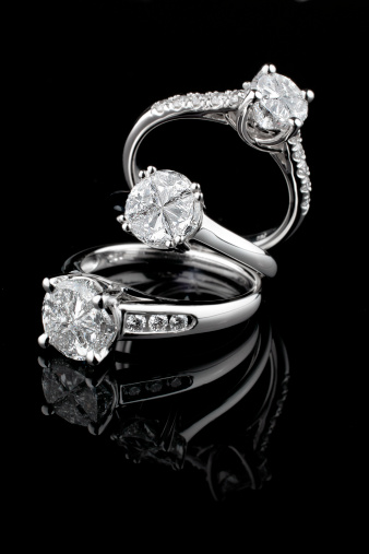 Three diamond jewel rings on black background