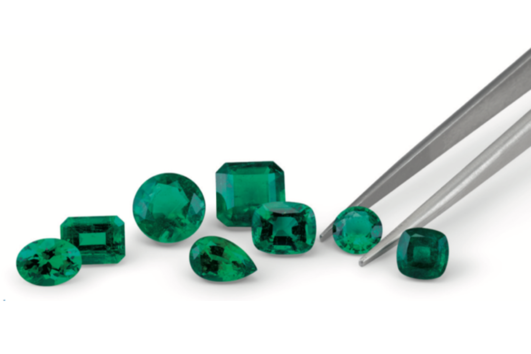 A prong selects one of the eight different green gemstone shapes and sizes