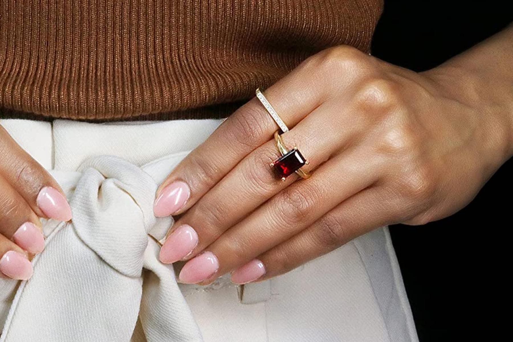 A woman's hand adorned with garnet ring
