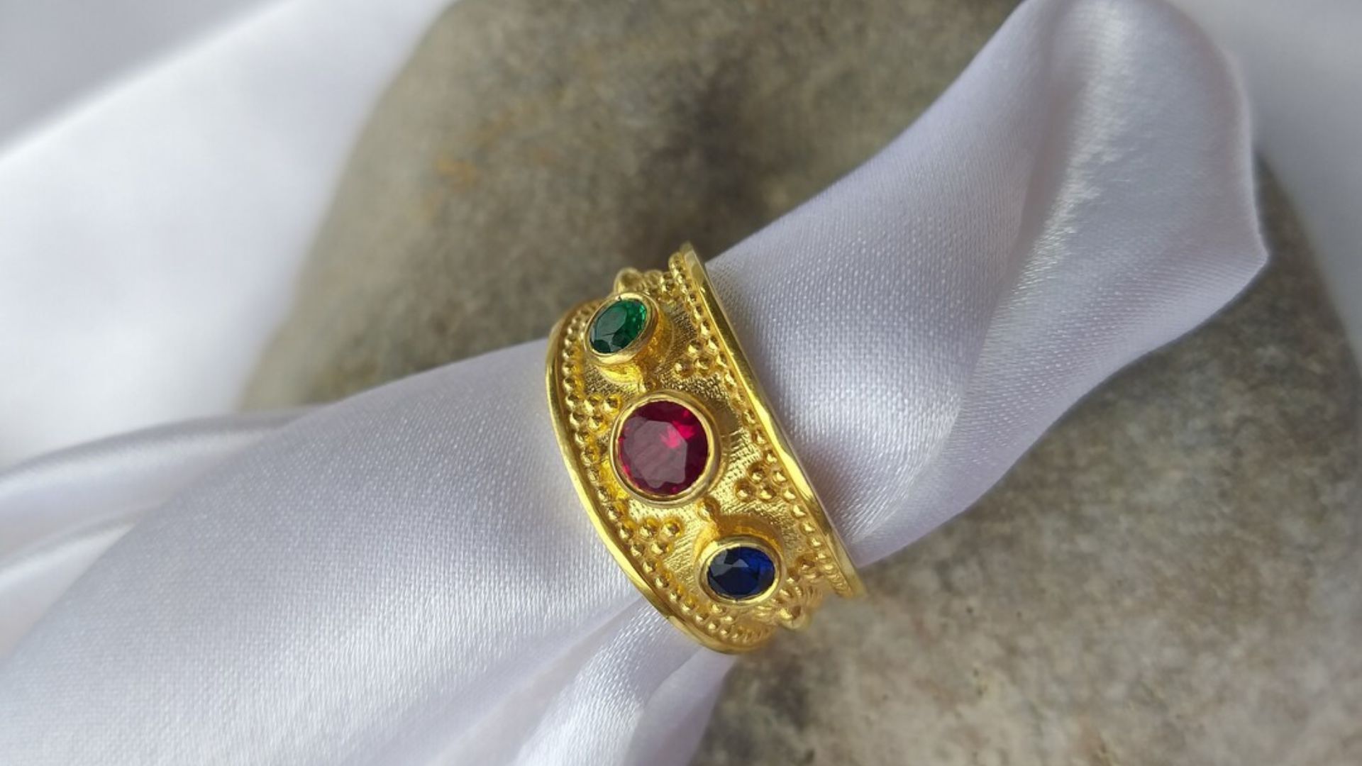 A Golden Ring With Red Green And Blue Stone