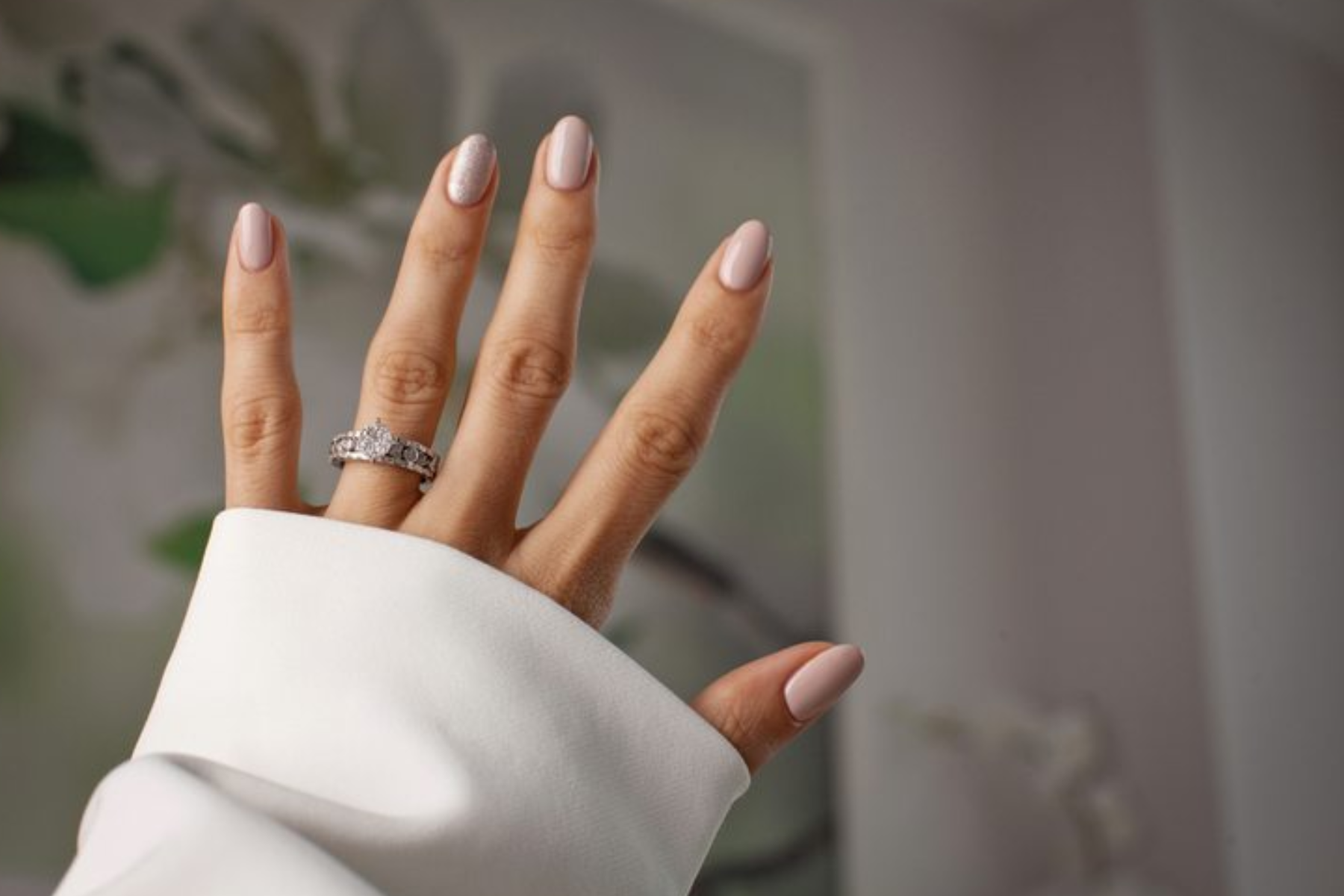 A woman's hand is adorned with a modern setting engagement ring